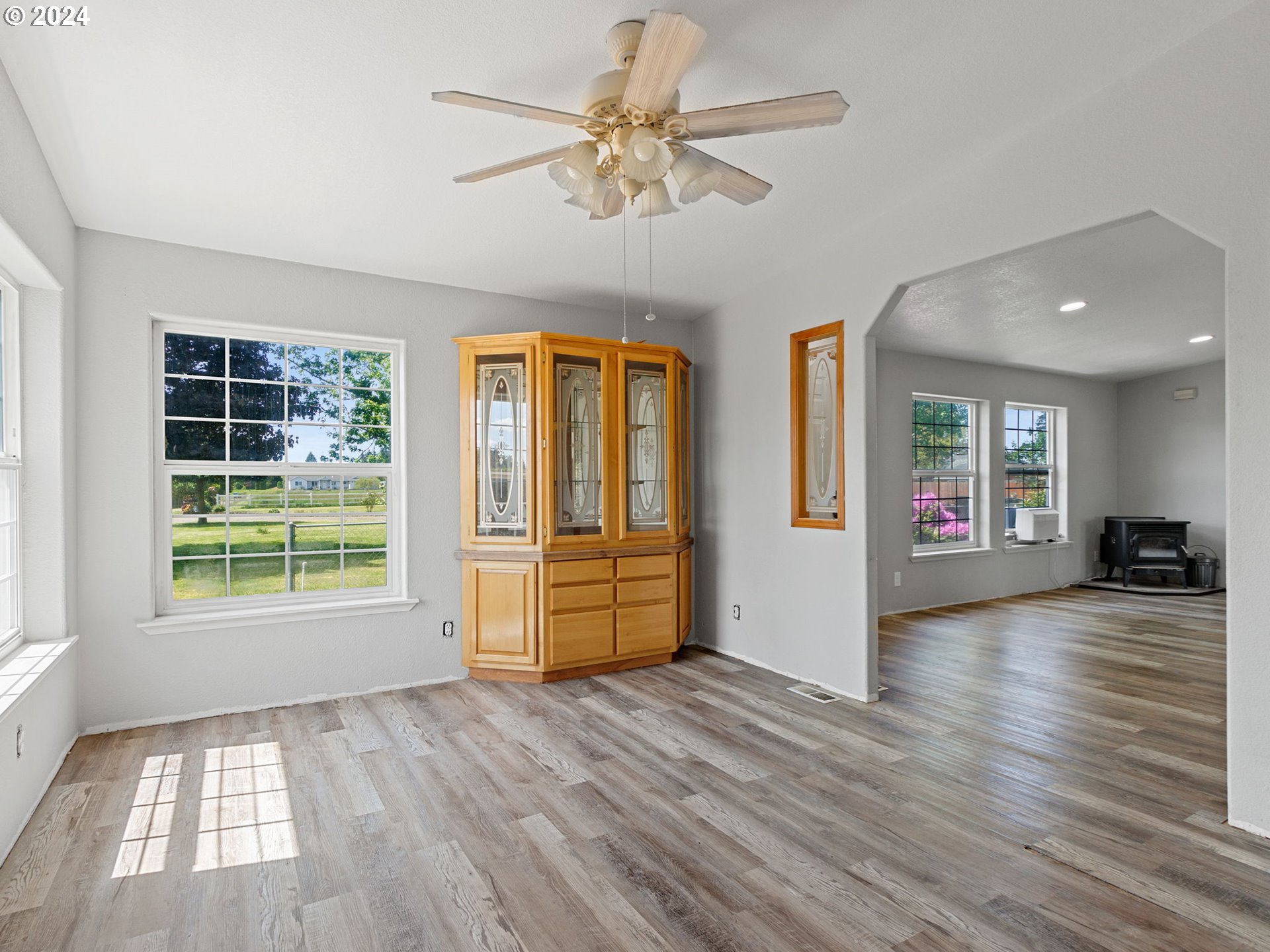 20221 Northeast 22nd Avenue Ridgefield, WA 98642 - Photo 20 of 39 wooden floor in an empty room with a window and a kitchen