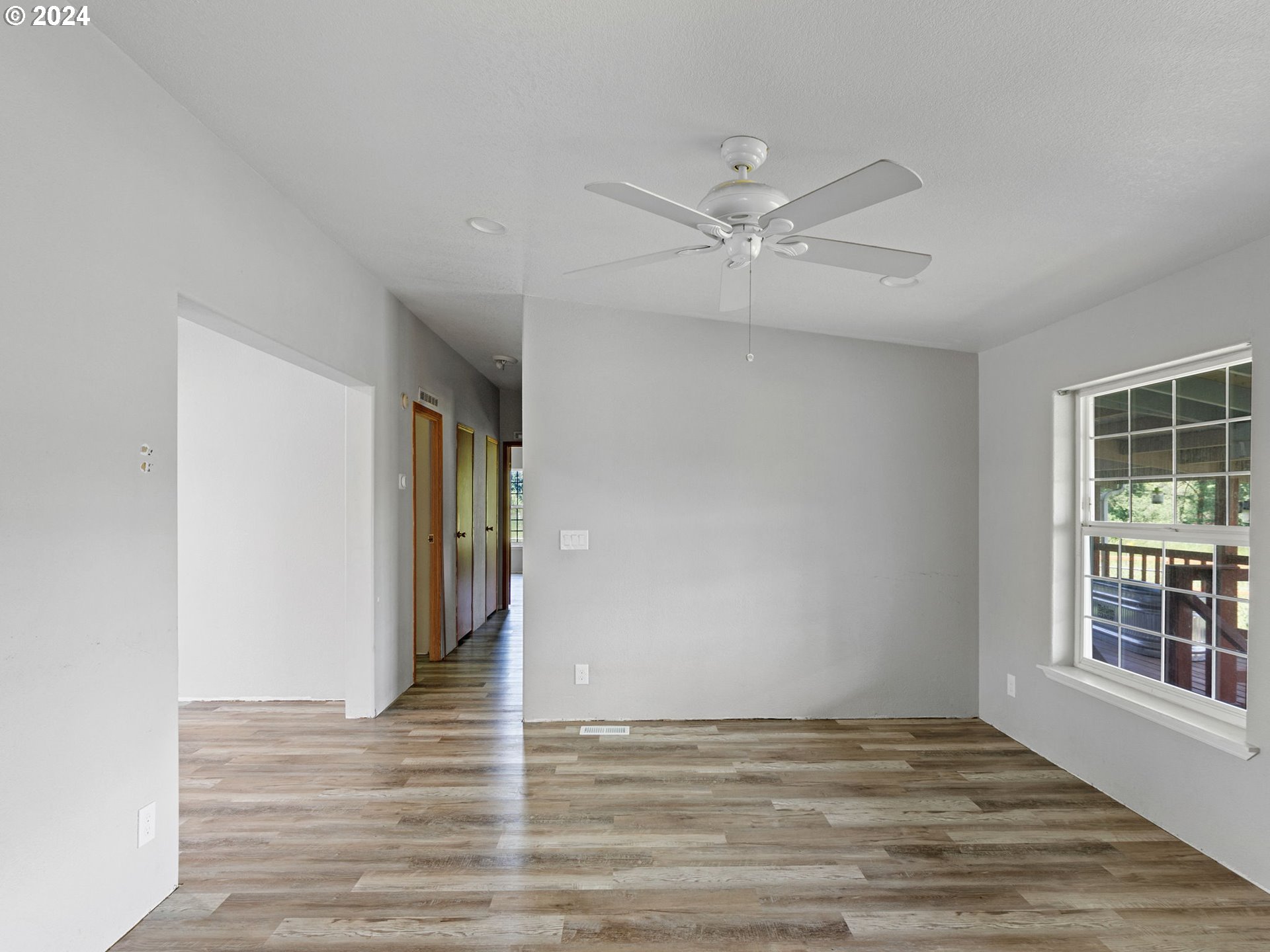 20221 Northeast 22nd Avenue Ridgefield, WA 98642 - Photo 23 of 39 a view of an empty room with wooden floor and a window