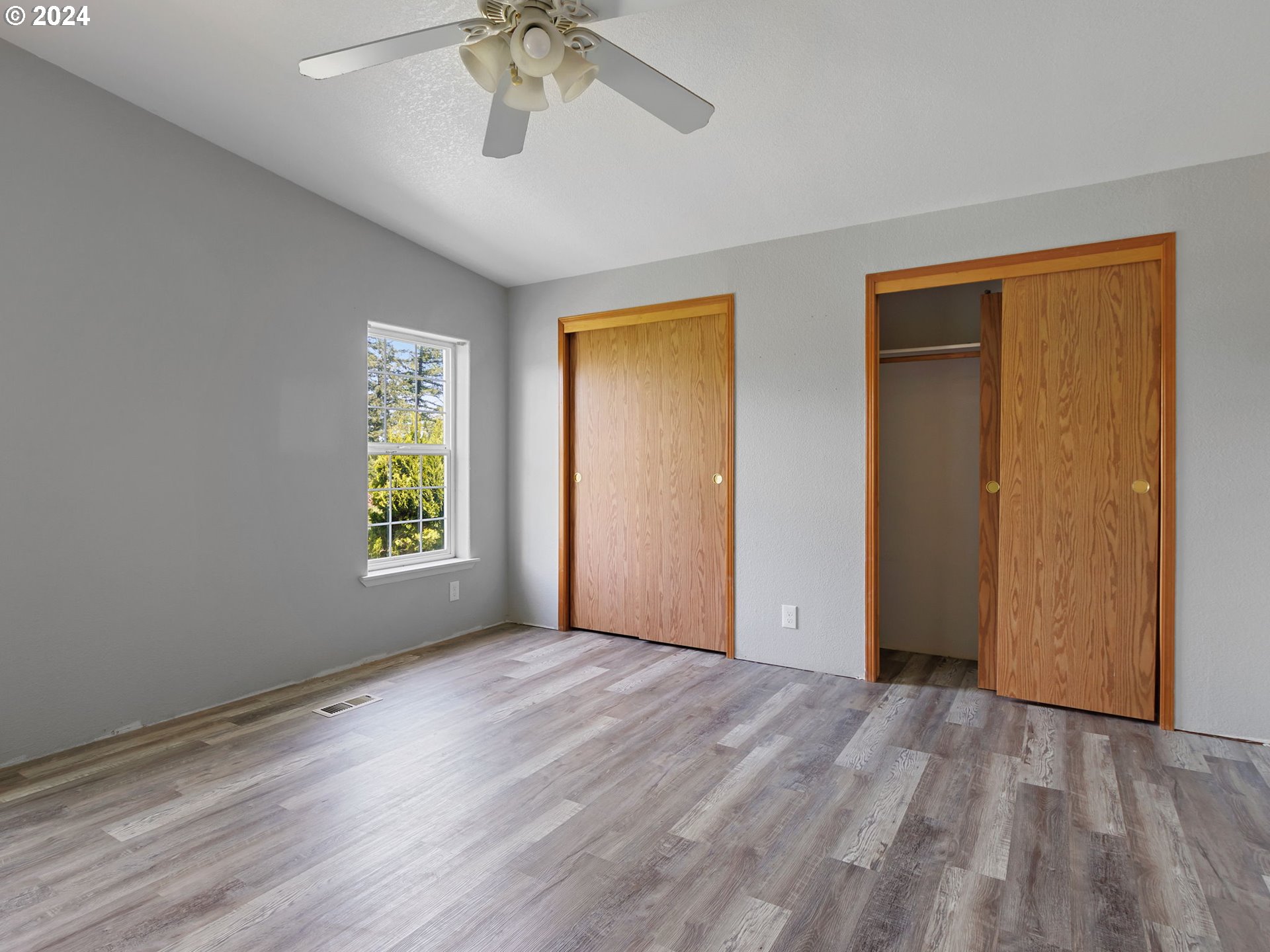 20221 Northeast 22nd Avenue Ridgefield, WA 98642 - Photo 25 of 39 a view of an empty room with window and wooden floor