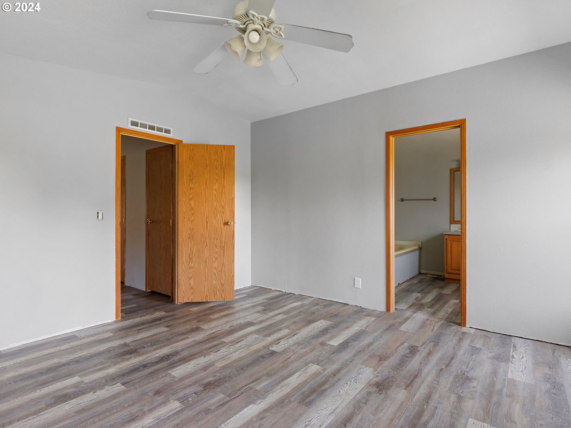 20221 Northeast 22nd Avenue Ridgefield, WA 98642 - Photo 26 of 39 a view of an empty room with wooden floor and closet