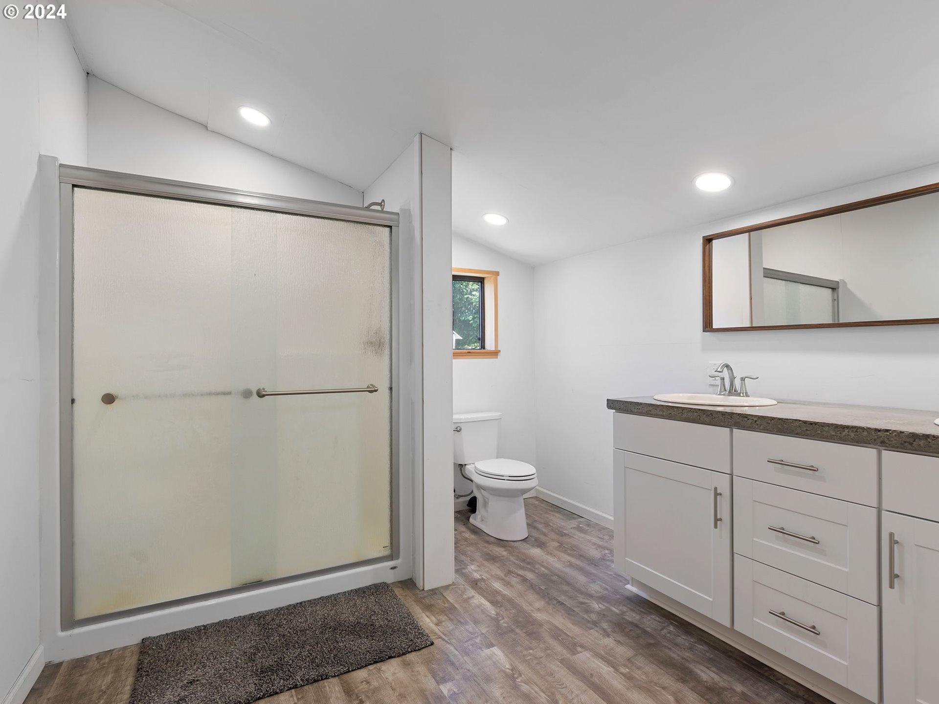 20221 Northeast 22nd Avenue Ridgefield, WA 98642 - Photo 36 of 39 a bathroom with a toilet a sink and mirror