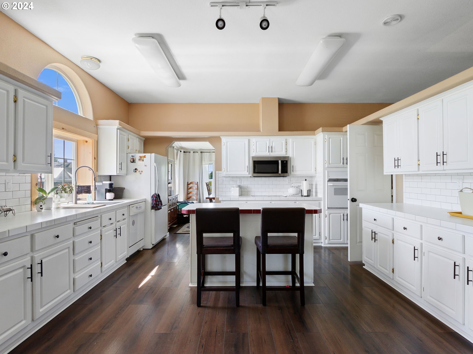 20221 Northeast 22nd Avenue Ridgefield, WA 98642 - Photo 6 of 39 a large white kitchen with cabinets