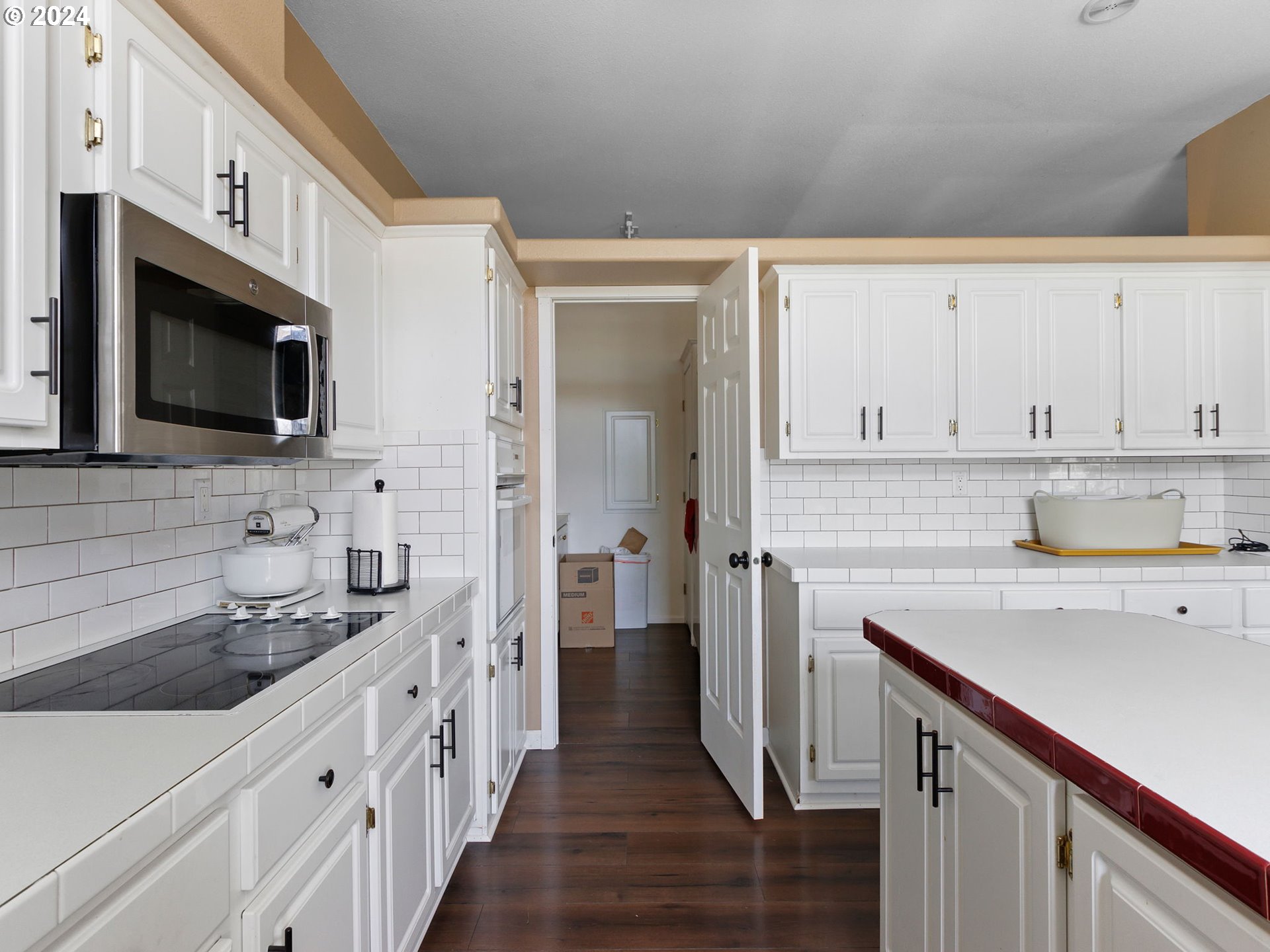 20221 Northeast 22nd Avenue Ridgefield, WA 98642 - Photo 7 of 39 a kitchen with cabinets stainless steel appliances a sink and wooden floor