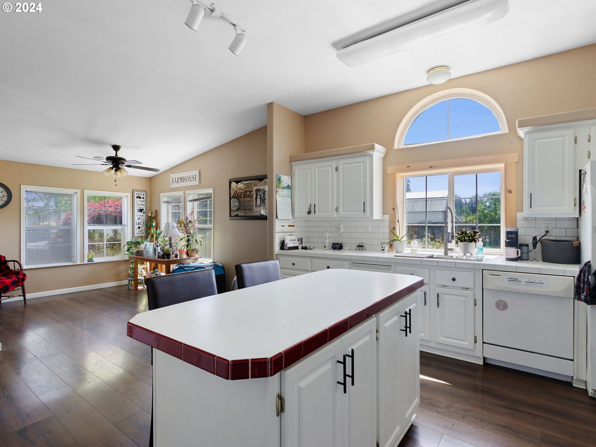 20221 Northeast 22nd Avenue Ridgefield, WA 98642 - Photo 8 of 39 a kitchen with a stove a sink dishwasher a dining table and chairs with wooden floor