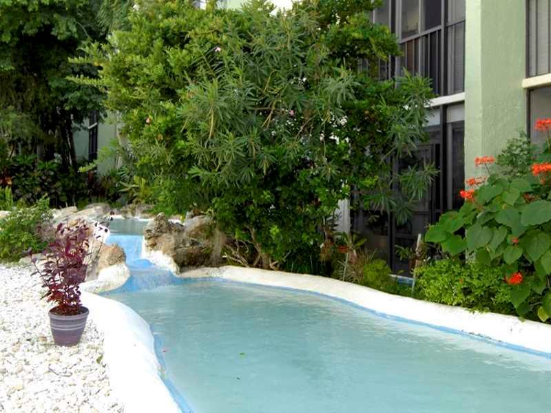 5321 Northeast 24th Terrace, Unit 512A Fort Lauderdale, FL 33308 - Photo 14 of 18 a view of a street with potted plants