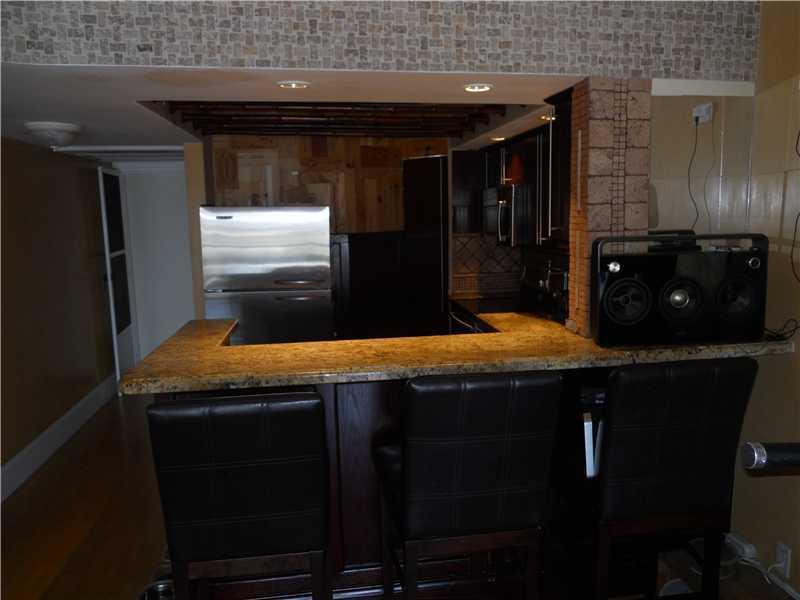 5321 Northeast 24th Terrace, Unit 512A Fort Lauderdale, FL 33308 - Photo 6 of 18 a kitchen with granite countertop a sink a stove and refrigerator