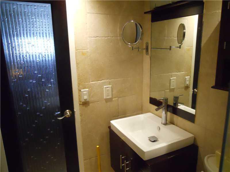 5321 Northeast 24th Terrace, Unit 512A Fort Lauderdale, FL 33308 - Photo 8 of 18 a bathroom with a sink mirror and shower