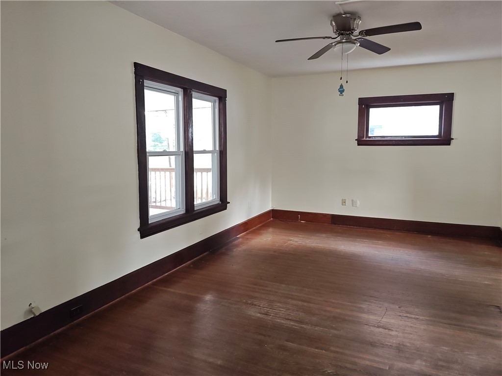 5213 Reed Avenue Ashtabula, OH 44004 - Photo 8 of 35 Unfurnished room with wood finished floors and a ceiling fan