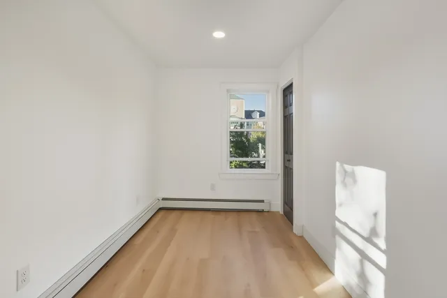 a view of room with window and hardwood floor