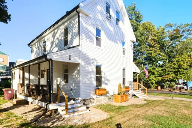a view of a building with yard and sitting area