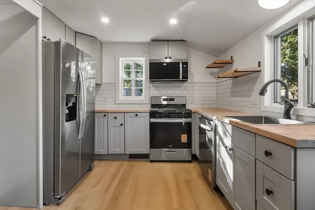 a kitchen with stainless steel appliances a refrigerator stove and sink