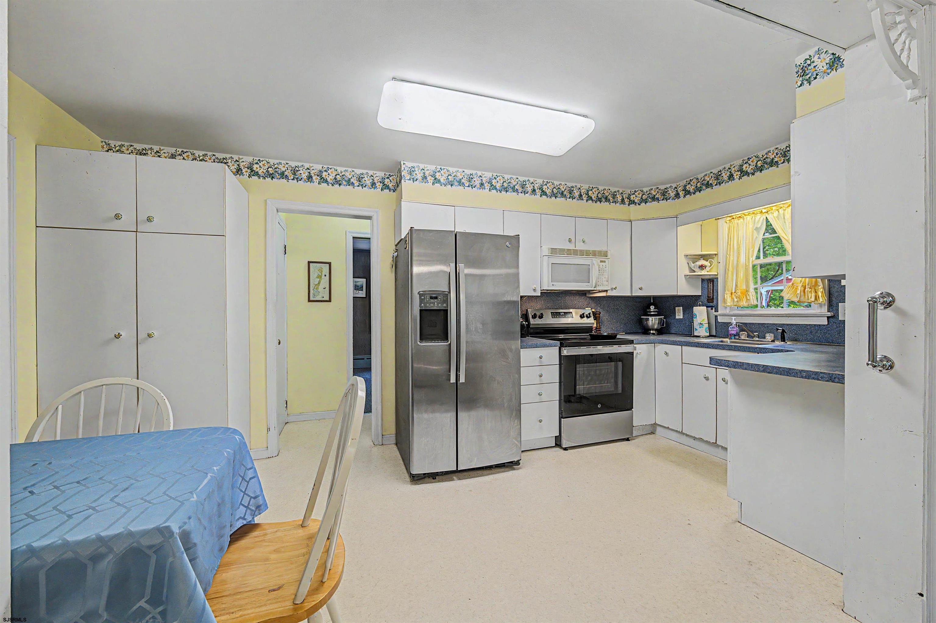 144 Pitney Road Absecon, NJ 08201 - Photo 21 of 47 a kitchen with granite countertop a refrigerator and a stove top oven