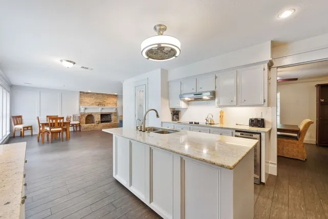 a kitchen with furniture a counter space a sink appliances and cabinets