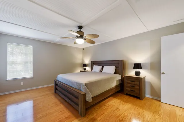 a bedroom with a bed and a chandelier