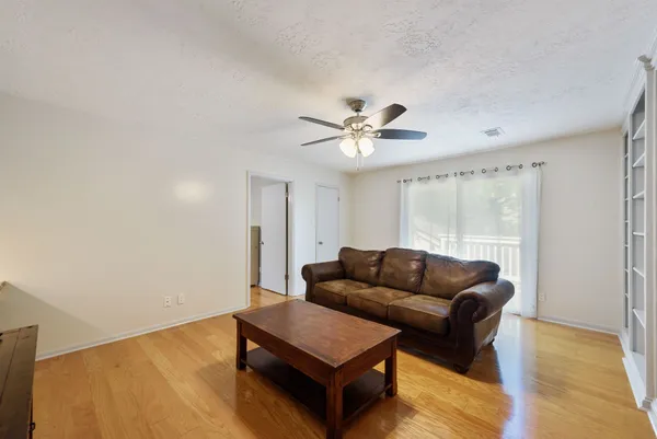 a living room with furniture and a wooden floor