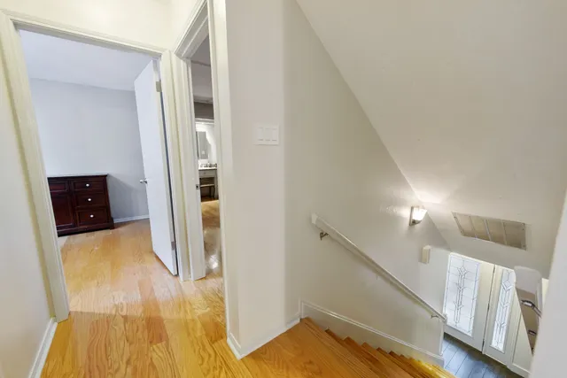 a view of a hallway view with wooden floor and staircase