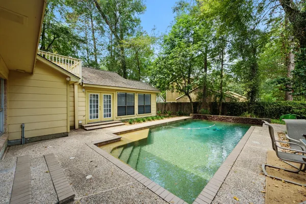 a view of a house with a yard and sitting area