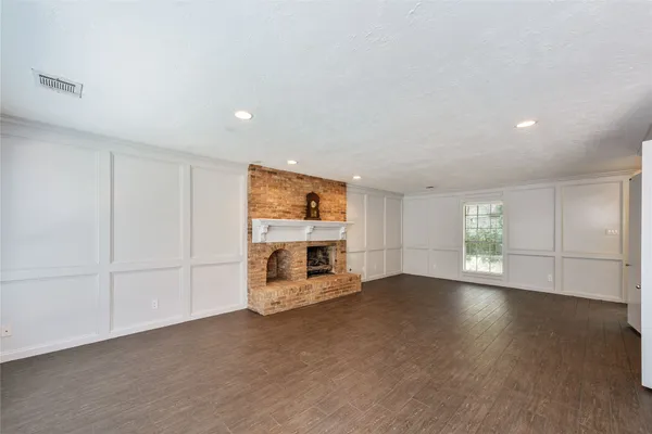 an empty room with fireplace and windows