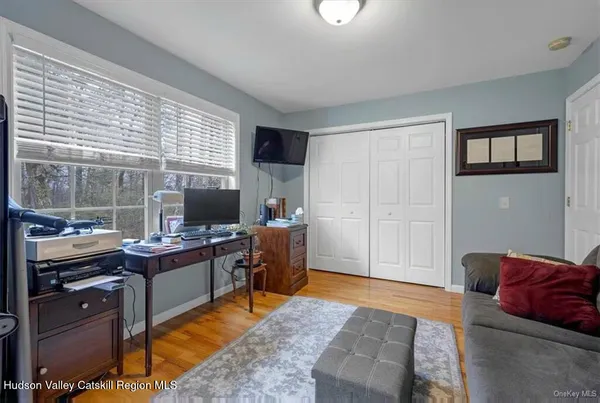 a view of a livingroom with workspace and a window