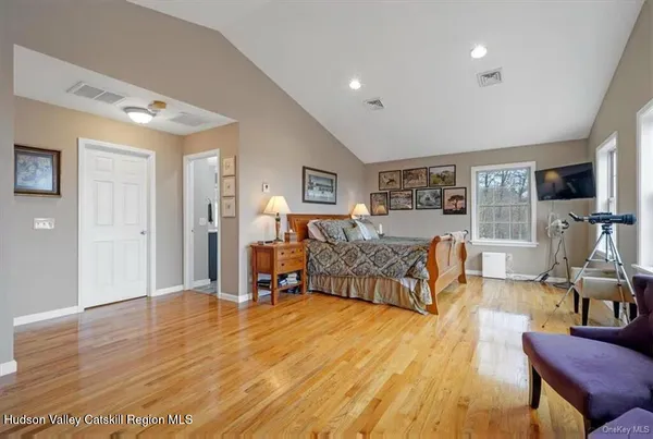 a spacious bedroom with a bed and a couch