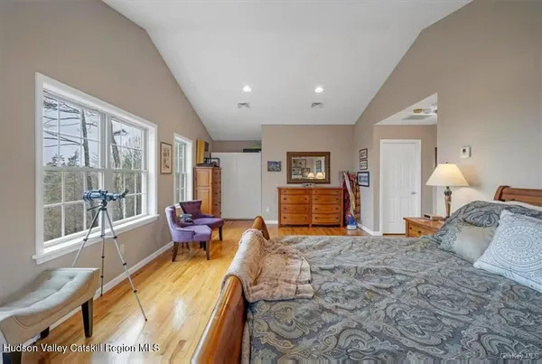 a bedroom with furniture and a large window