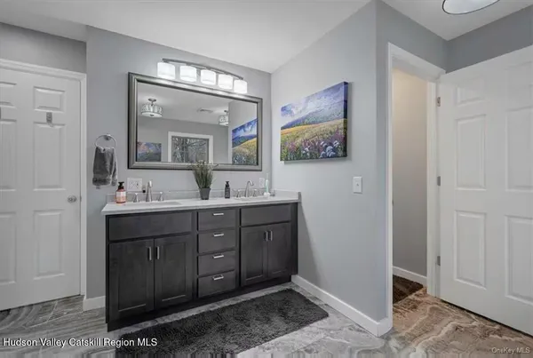 a bathroom with a double vanity sink and a mirror