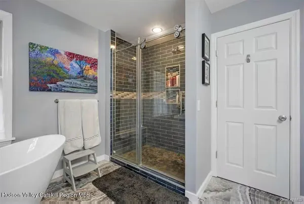 a bathroom with a bathtub and a shower