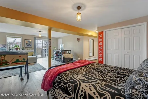 a bed sitting in a bedroom next to a window