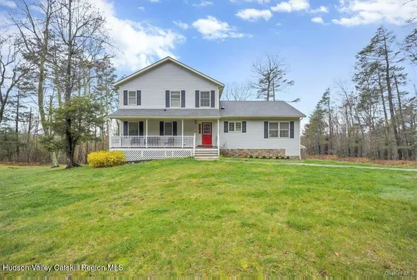 a view of a house with a yard table and chairs