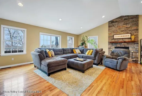 a living room with fireplace furniture and a flat screen tv
