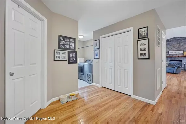 a view of a bedroom with wooden floor and closet