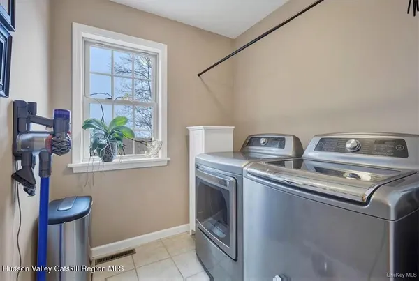 a utility room with dryer washer and a window