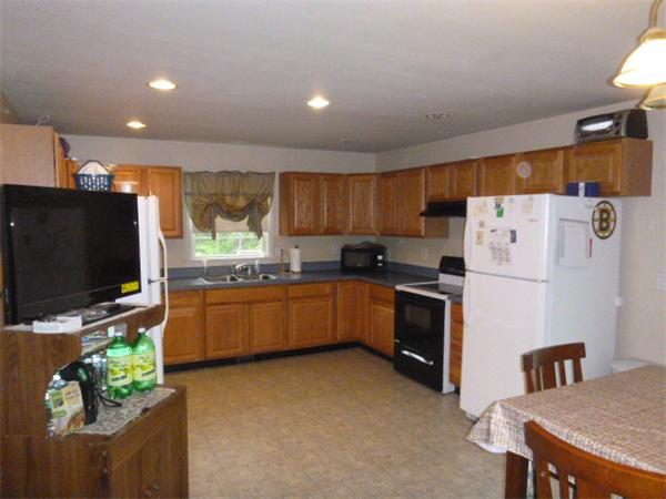 3730 Greenwich Road Hardwick, MA 01082 - Photo 8 of 15 a kitchen with a refrigerator a stove top oven a sink and cabinets