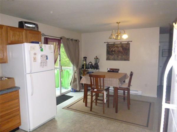 3730 Greenwich Road Hardwick, MA 01082 - Photo 9 of 15 a kitchen with a refrigerator a dining table and chairs