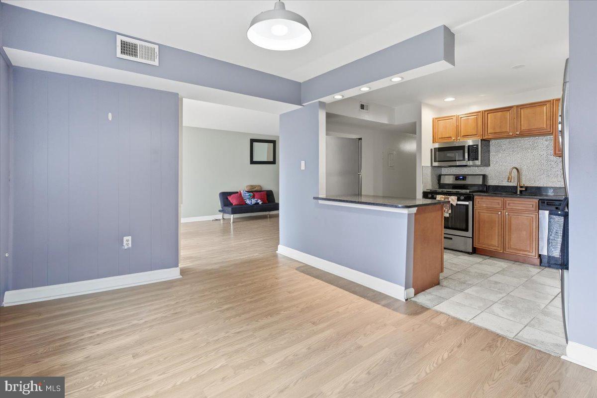 a kitchen with granite countertop a stove and a refrigerator
