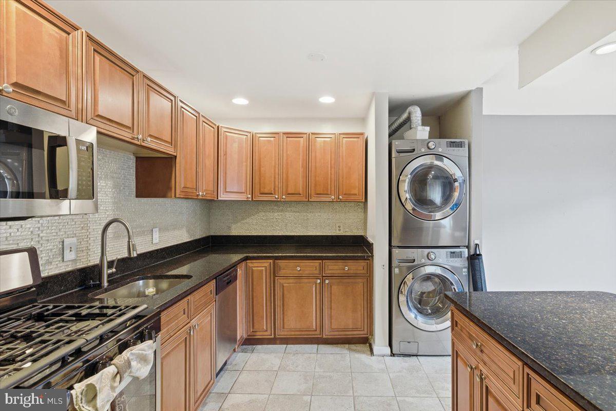 8459 Greenbelt Road, Unit T1 Greenbelt, MD 20770 - Photo 10 of 27 a kitchen with a sink a stove and cabinets