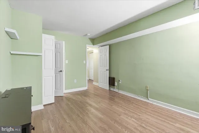 a view of an empty room and wooden floor