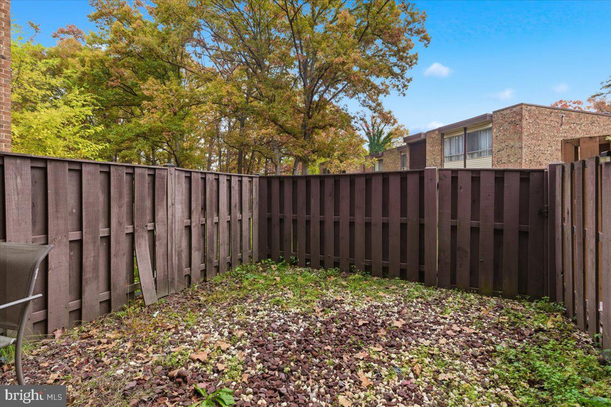 8459 Greenbelt Road, Unit T1 Greenbelt, MD 20770 - Photo 21 of 27 a backyard of a house with trees