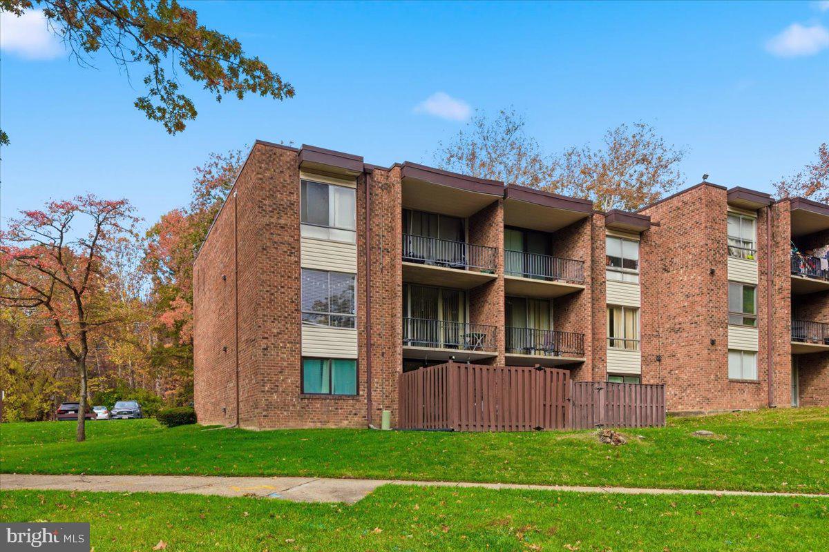 8459 Greenbelt Road, Unit T1 Greenbelt, MD 20770 - Photo 26 of 27 a view of a house with a yard