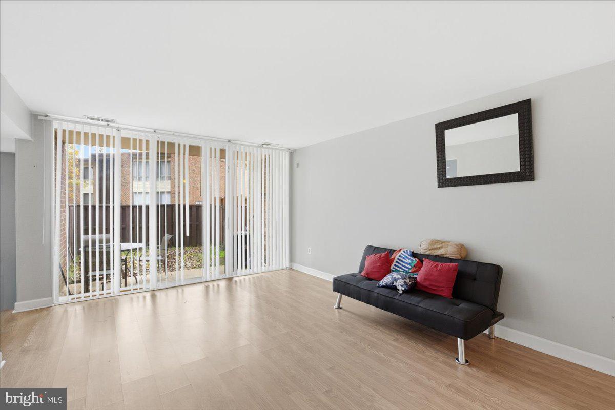 8459 Greenbelt Road, Unit T1 Greenbelt, MD 20770 - Photo 4 of 27 a living room with furniture and a wooden floor