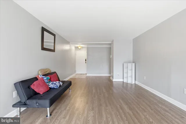 a very nice looking room with wooden floor and chair