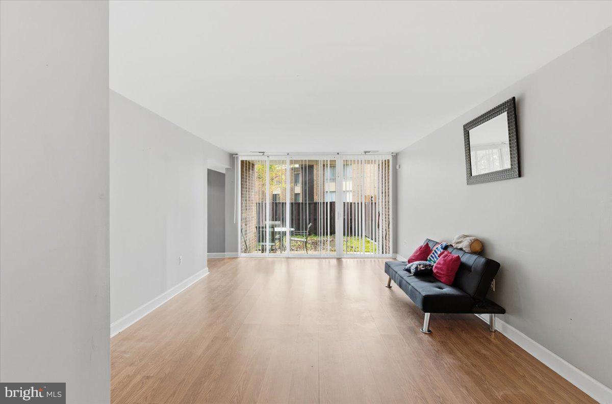 8459 Greenbelt Road, Unit T1 Greenbelt, MD 20770 - Photo 6 of 27 a living room with furniture and wooden floor