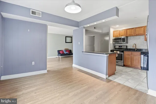 a kitchen with granite countertop a stove and a refrigerator