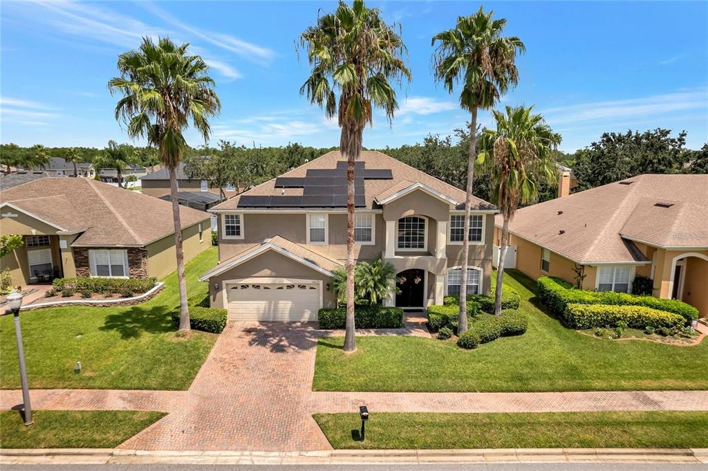 10023 Ians Ridge Road Orlando, FL 32832 - Photo 49 of 60 a front view of a house with garden