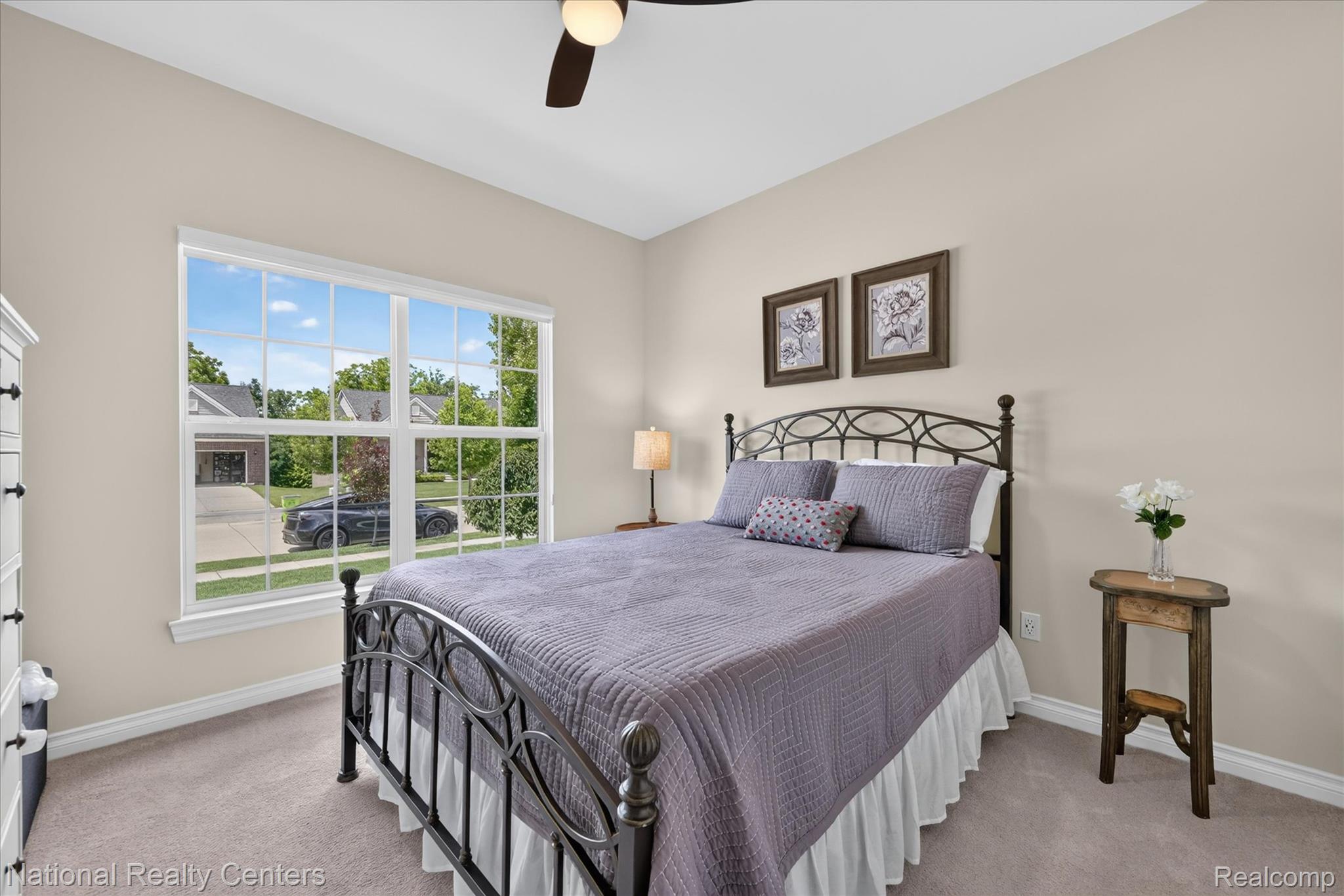 740 North Mill Street South Lyon, MI 48178 - Photo 26 of 56 Bright room featuring a large multi-pane window, neutral-toned walls, recessed lighting, and a ceiling fan