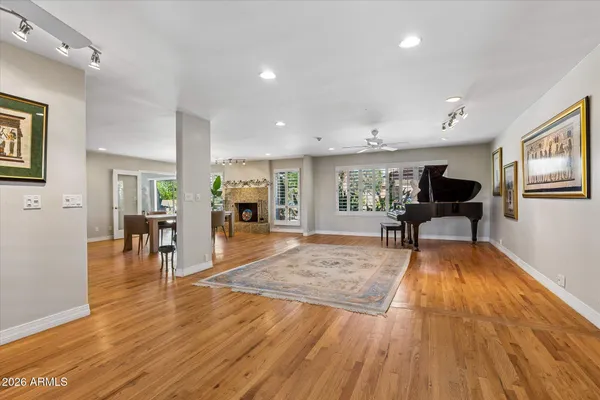 a living room with furniture and a ceiling fan