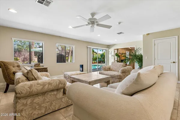 a view of a dining room with furniture a fireplace and wooden floor