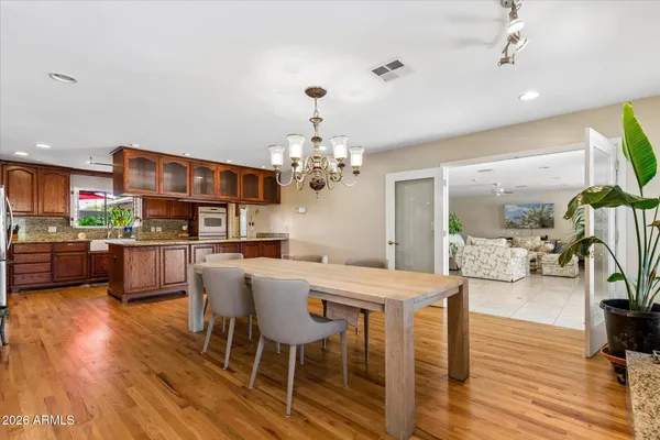 a kitchen with stainless steel appliances granite countertop a sink and a refrigerator