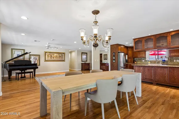 a kitchen with stainless steel appliances granite countertop a sink a stove and a wooden floors