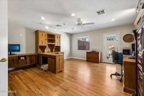 a bathroom with a granite countertop sink toilet mirror and shower